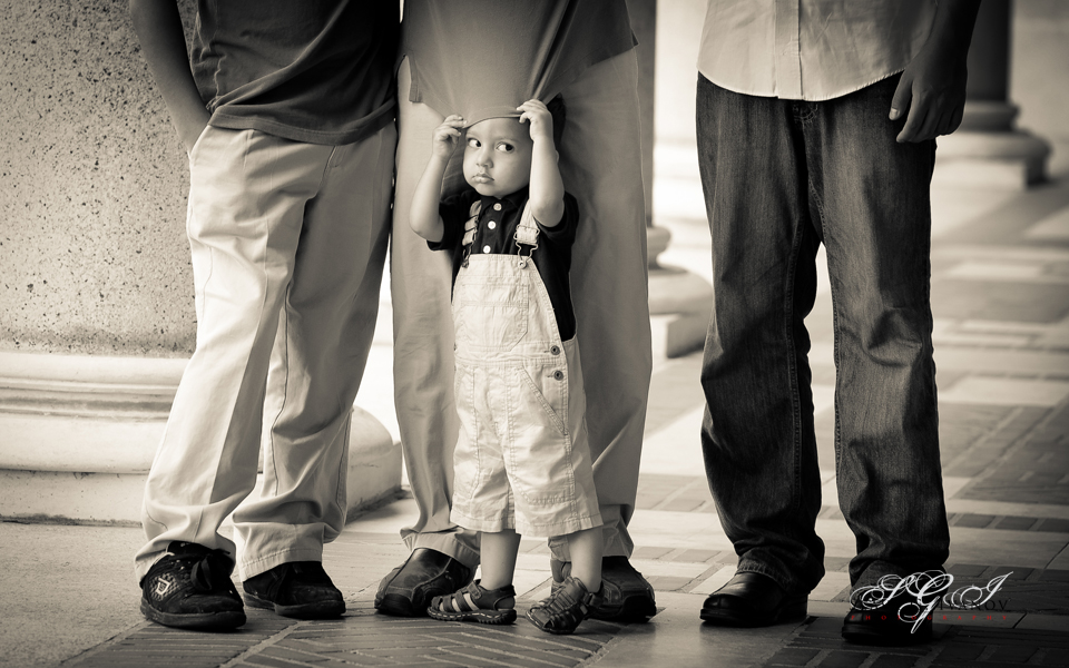 Little boy, standing in front of his family in Houston